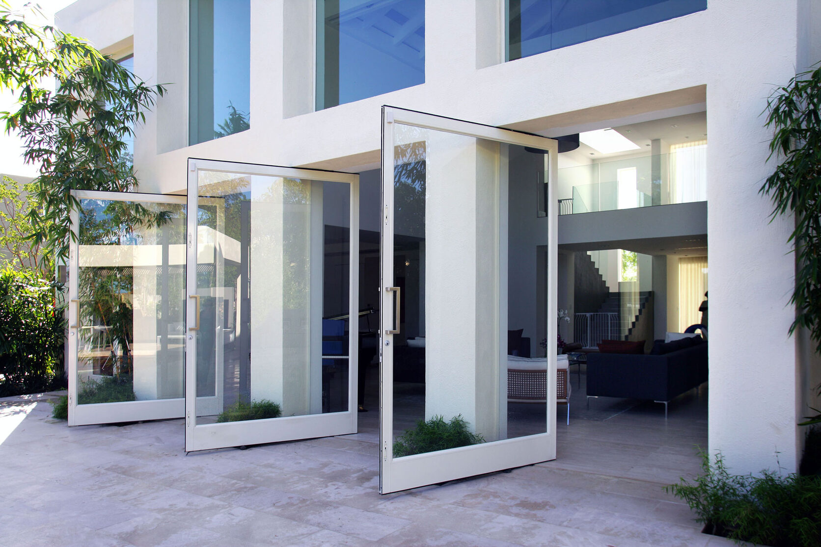 Air Master pivot glass entry doors on a modern Caribbean villa