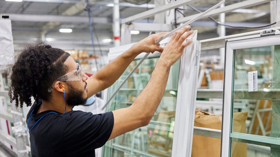 A CWS team member assembling a vinyl impact window