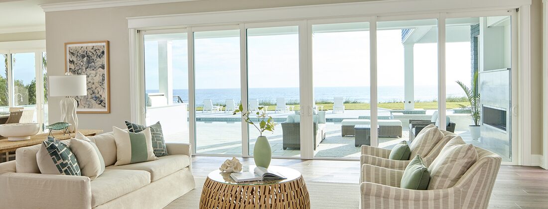 CWS impact windows framing an ocean view from a Florida living room
