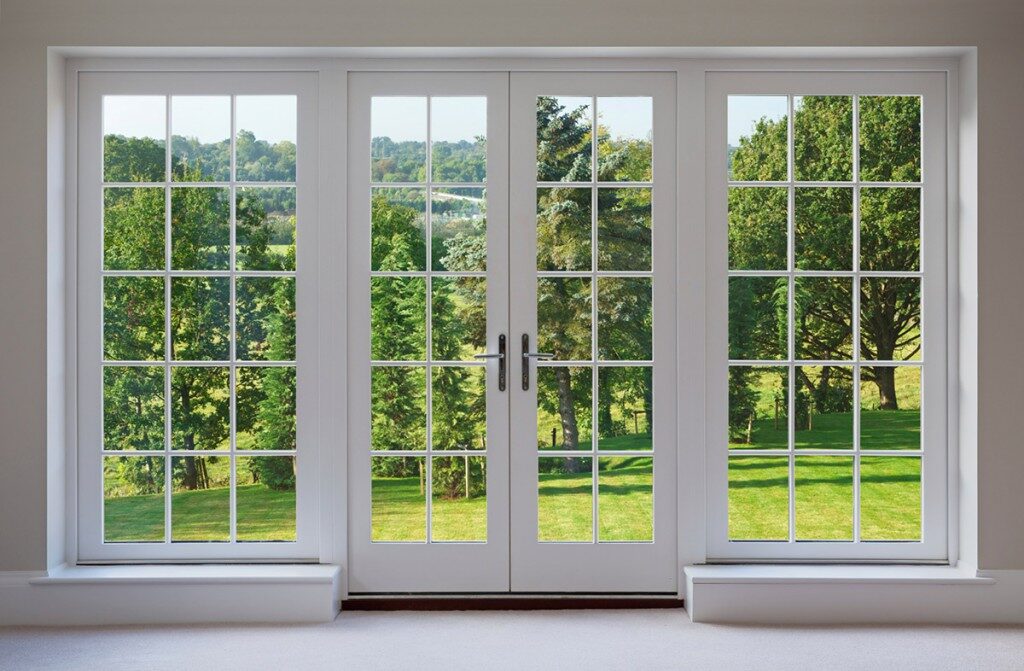 Eastern Architectural Systems impact French doors opening onto a Florida lawn