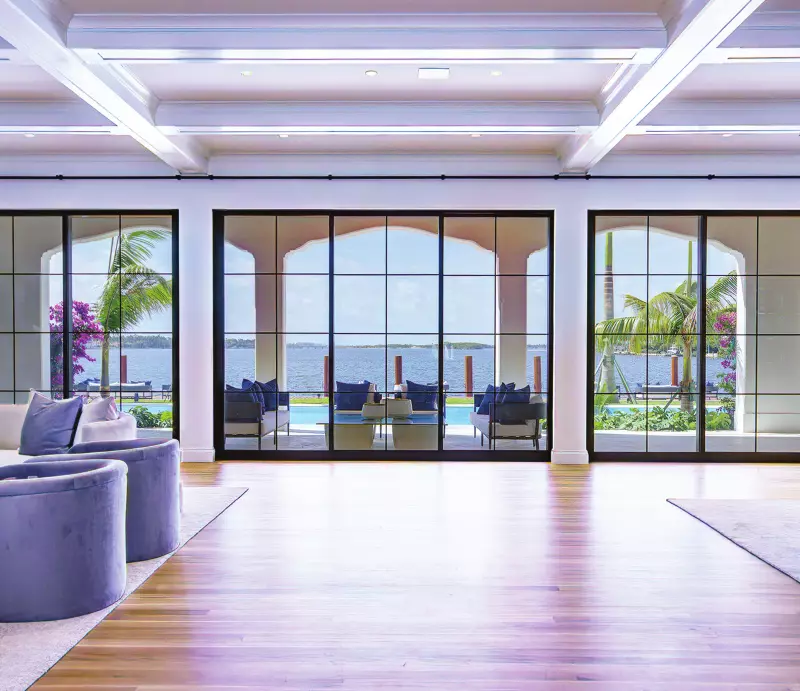 ES Windows Prestige black-framed sliding and picture doors in a waterfront living room